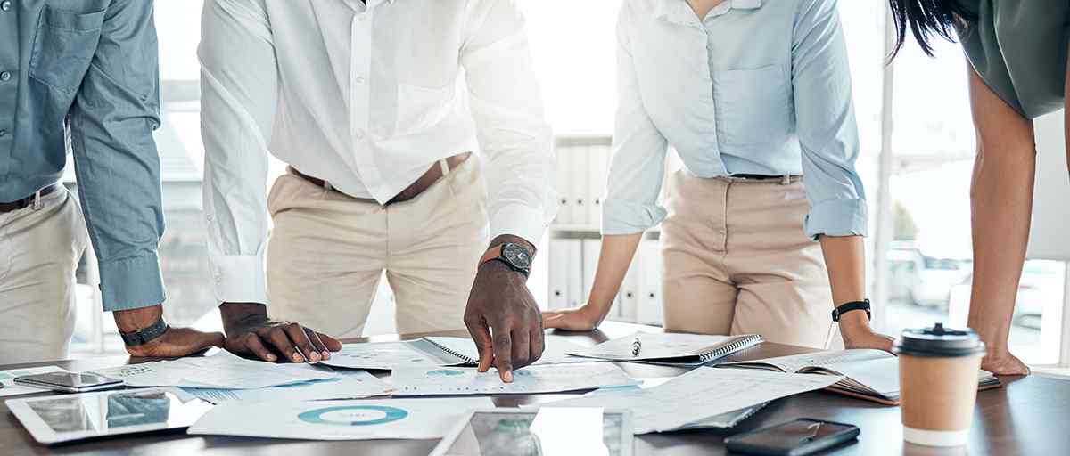 Close-up of business people in the office analyzing data to create the perfect Ideal Customer Profile (ICP)