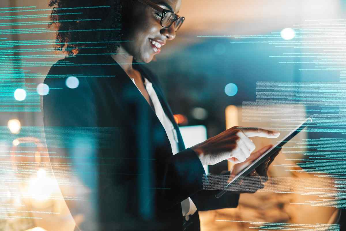 Businesswoman working on an iPad, surrounded by cyber lines, exploring future techniques for predictable customer journey mapping.