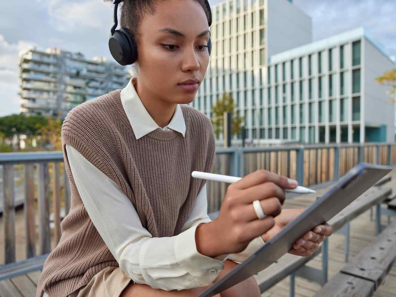 Young woman using a digital pen on a tablet, representing growth strategies for startups.