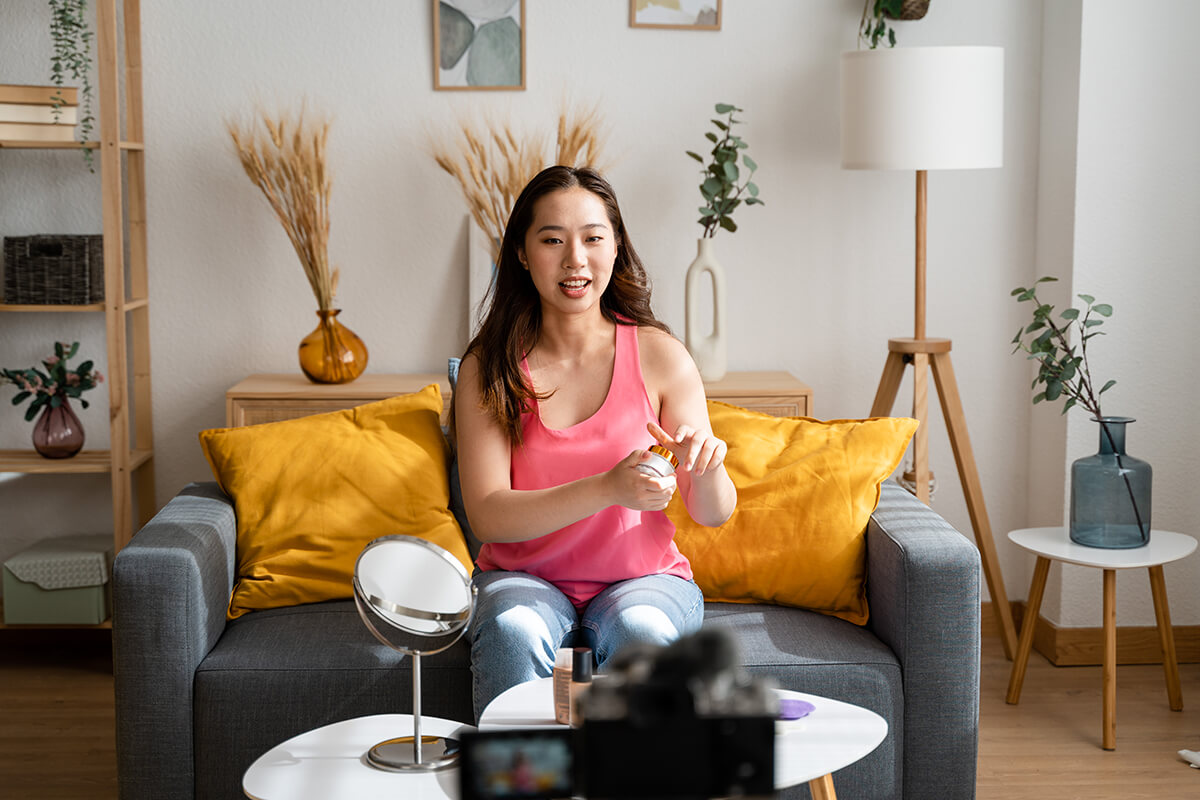 Woman applying skincare product while filming content for social media advertising