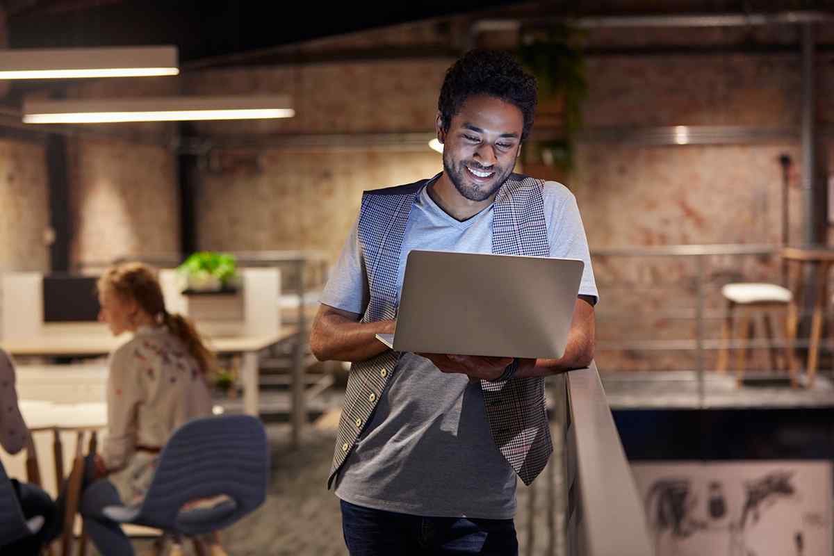 Introverted founder working on laptop at casual networking event