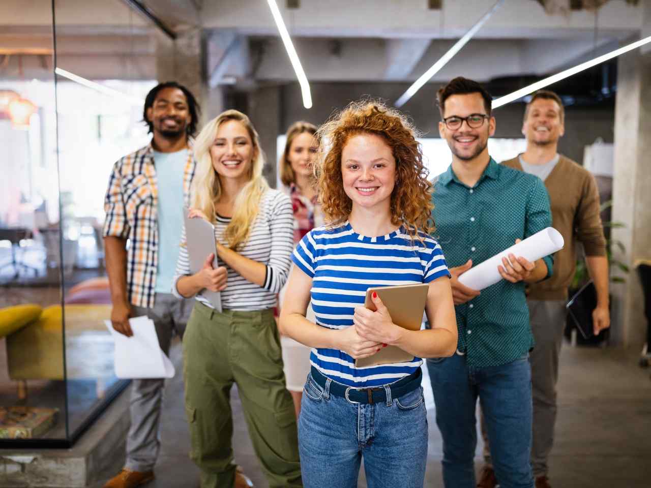 Group of young professionals in a modern office, symbolizing startup growth strategies.