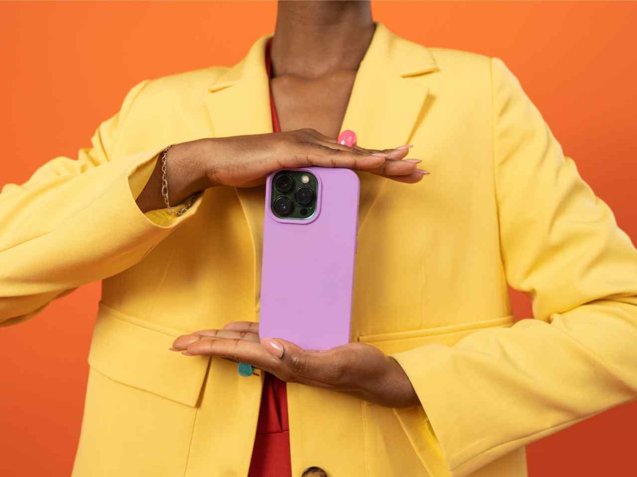 erson in a yellow blazer holding a smartphone, symbolizing digital growth strategies for startups.