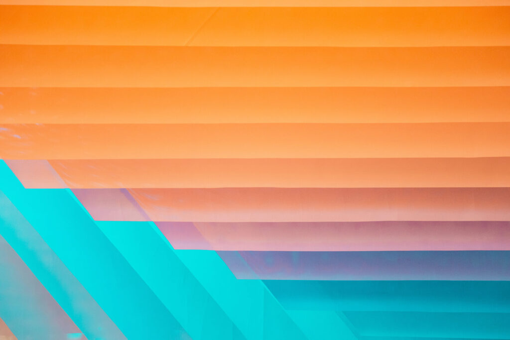 Abstract geometric pattern in orange and teal colors.