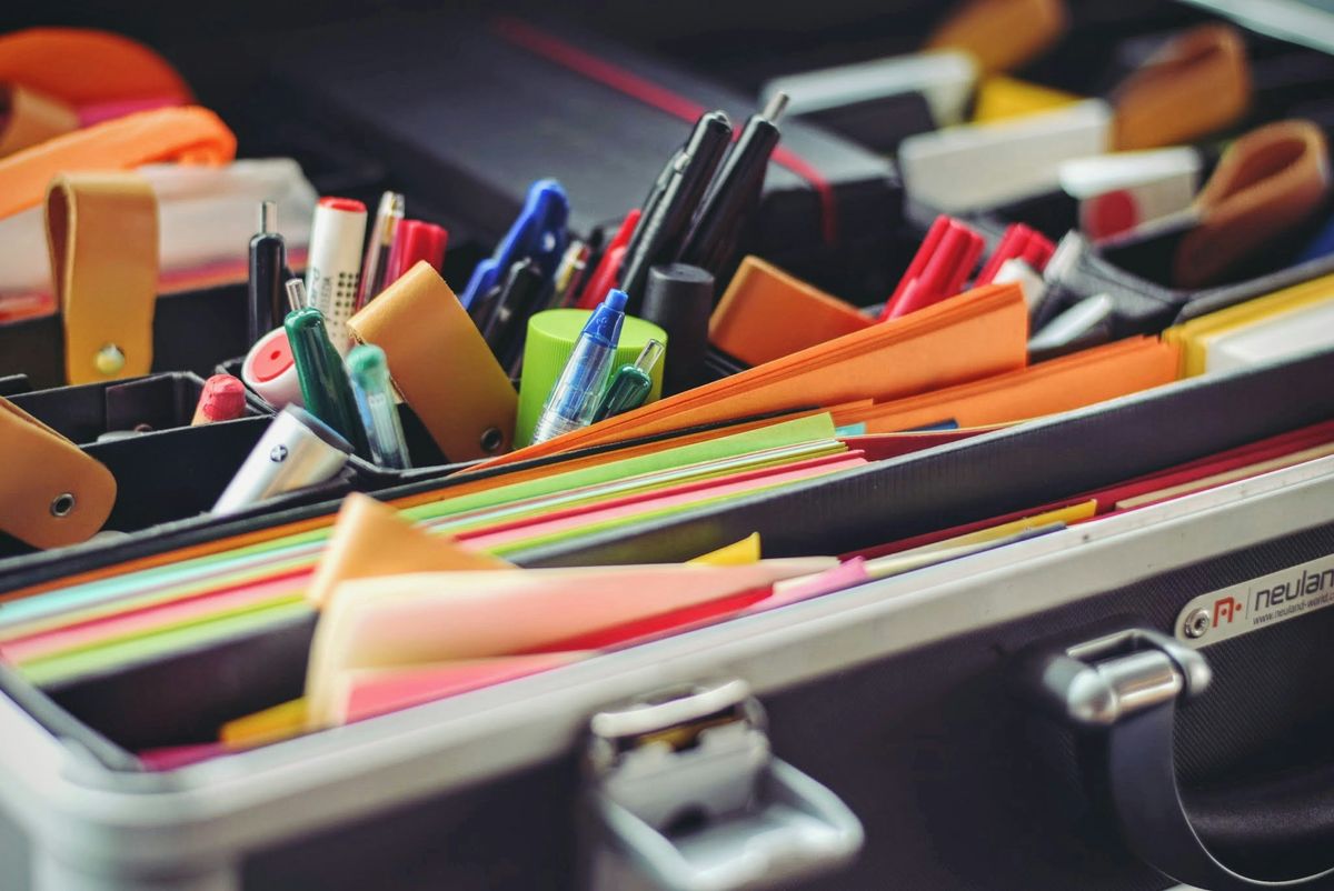 Close-up of organized stationery and office supplies in a case. A symbol of the role of branding in digital product design.