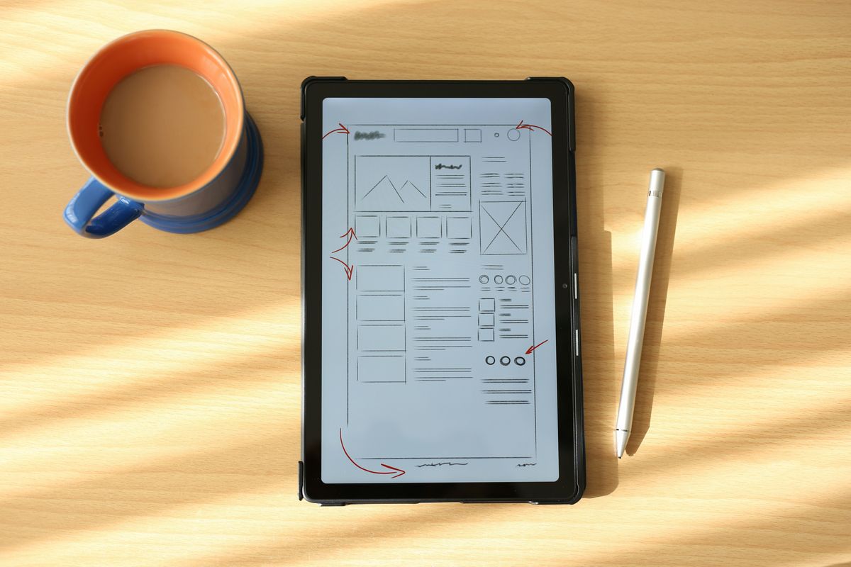 Tablet displaying a wireframe digital product design.